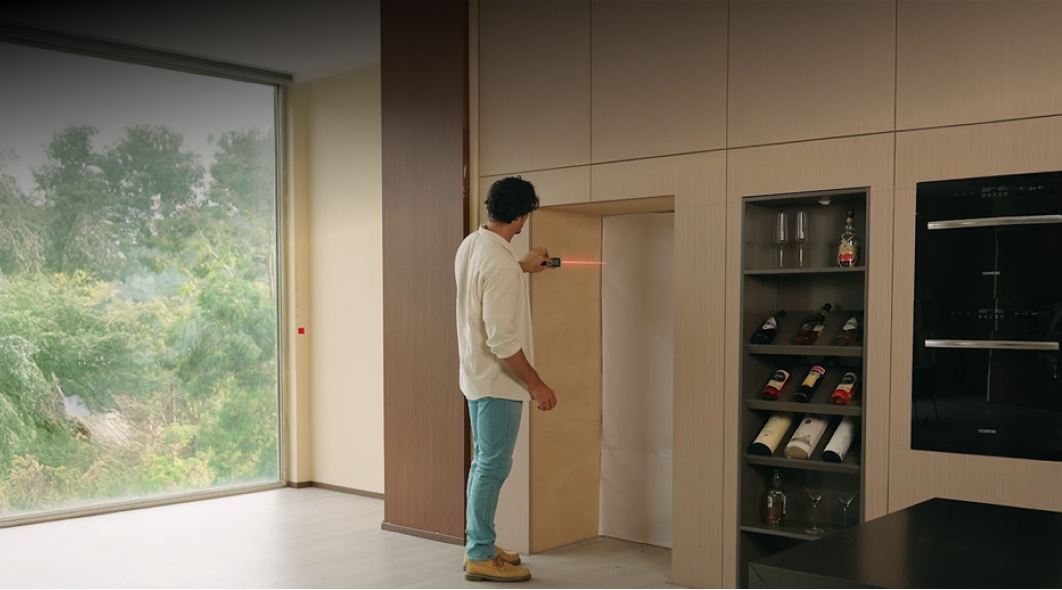 MILESEEY XTAPE1 measuring an interior cabinet opening