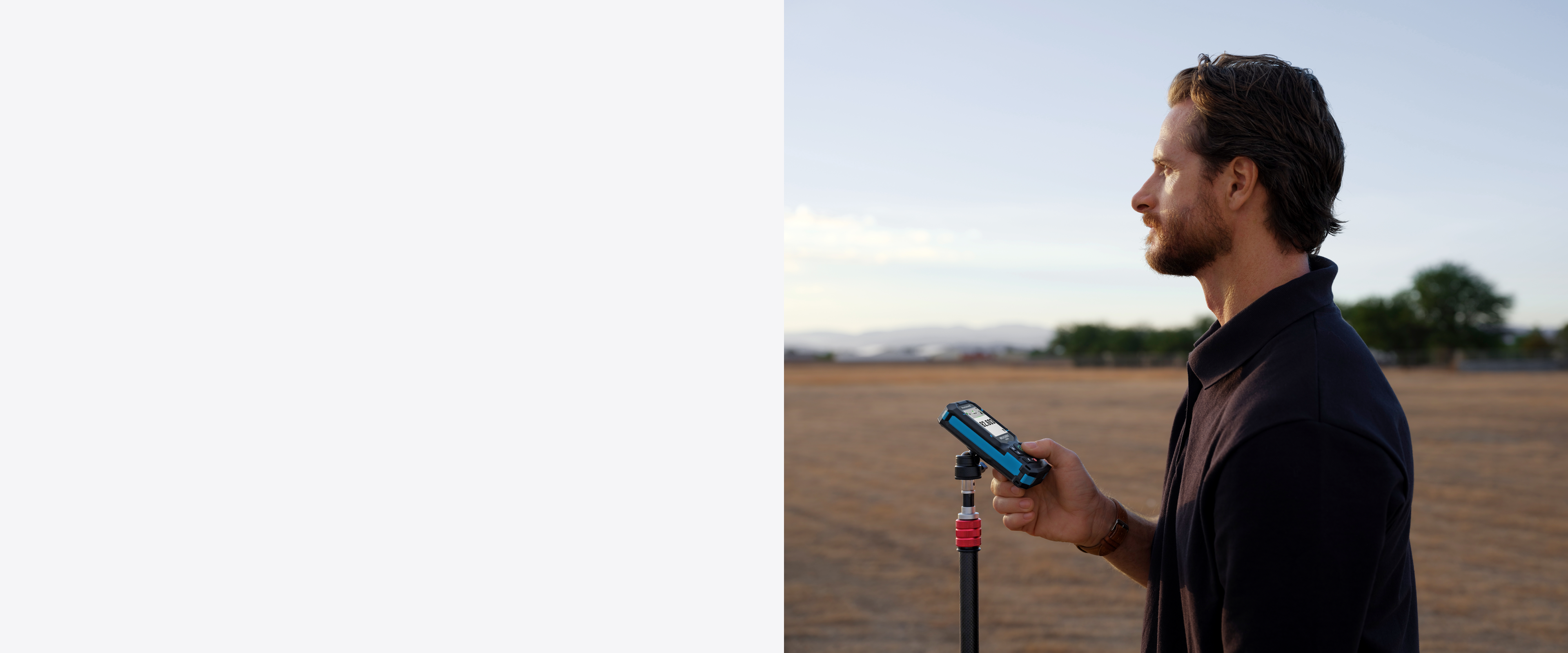 Mileseey S50 green laser measure held for outdoor surveying.